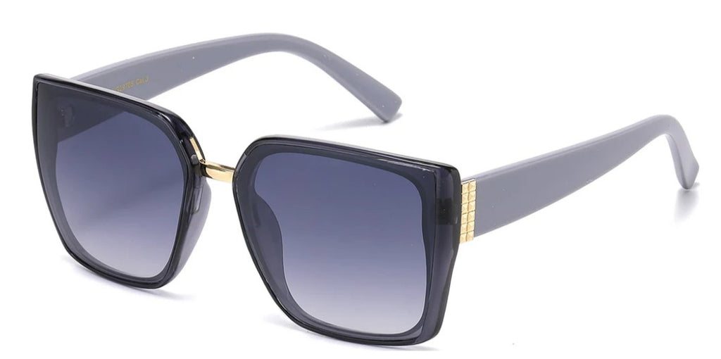 Oversize lens sunglasses with black gradient lenses, grey arms, and gold accents on a white background